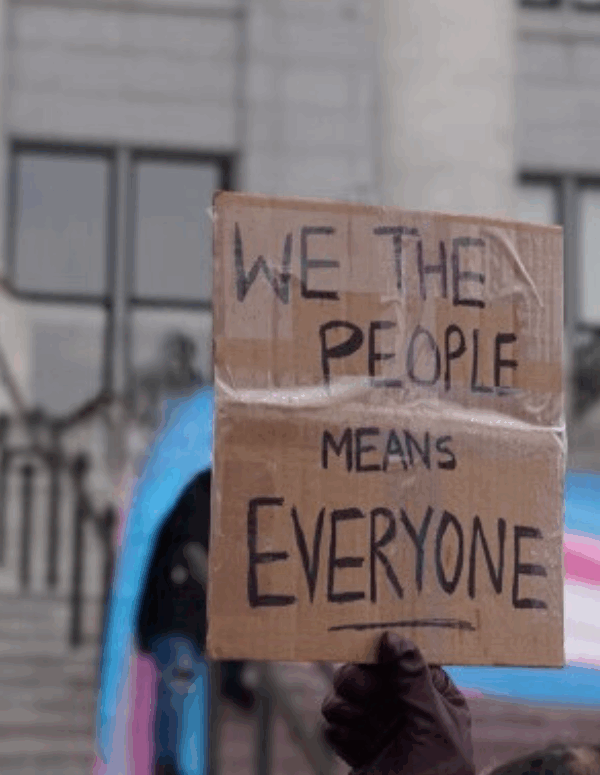 we trhe people mean everyone sign at a transgender rights rally.