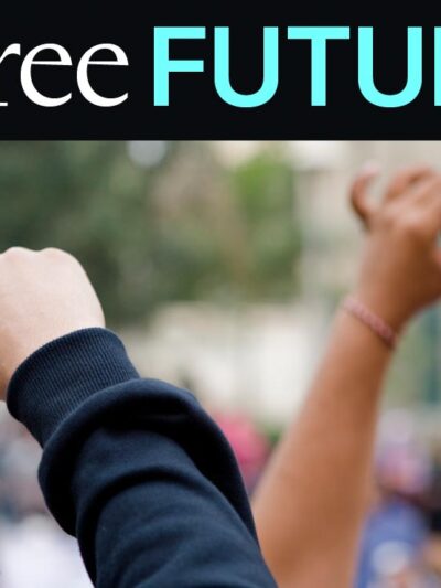 Hands in the air holding cellphones with a protest in background