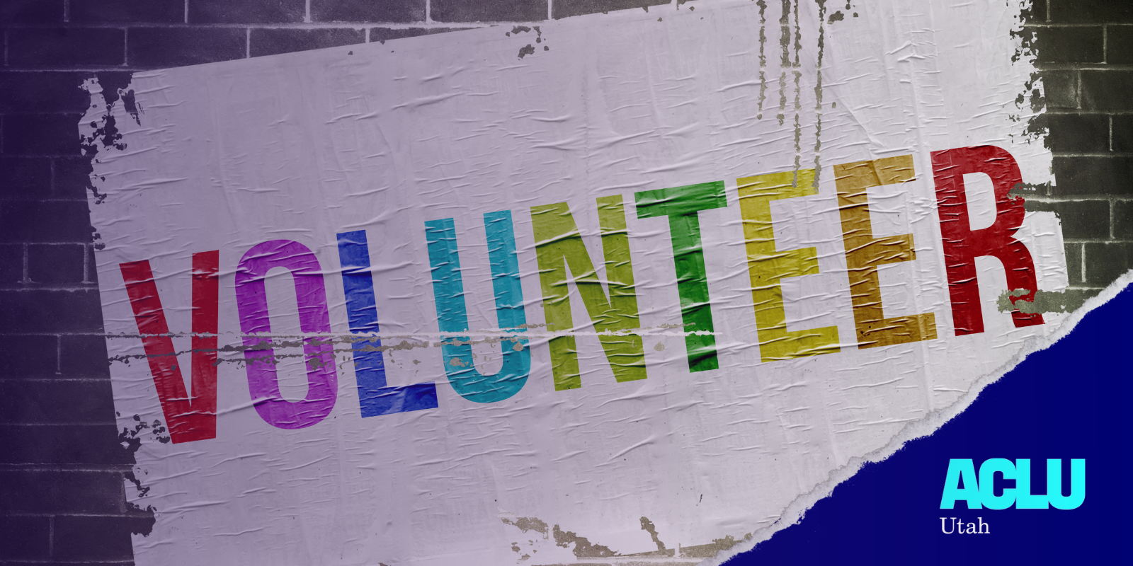 A photo of a brick wall painted with volunteer in rainbow colored lettering on a white back drop. In the left corner the ACLU Utah logo is in white.